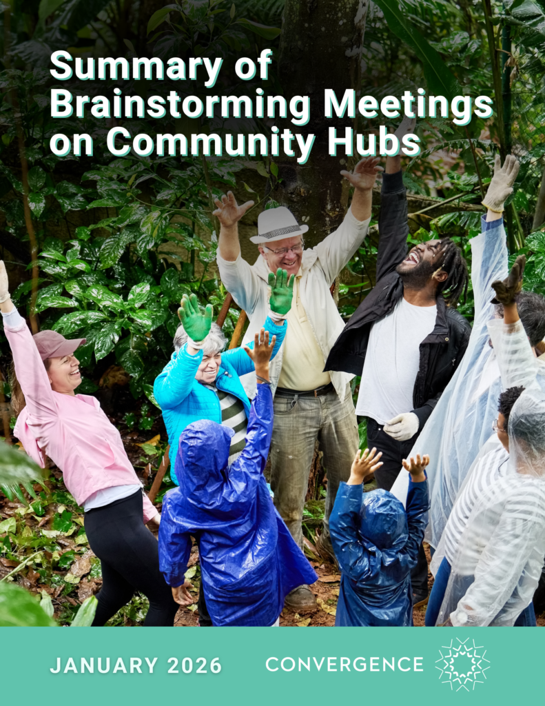 People gathered in rain gear and casual clothing in a green forest setting, participating in an energetic team moment.